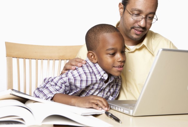 African American father helping son with homework