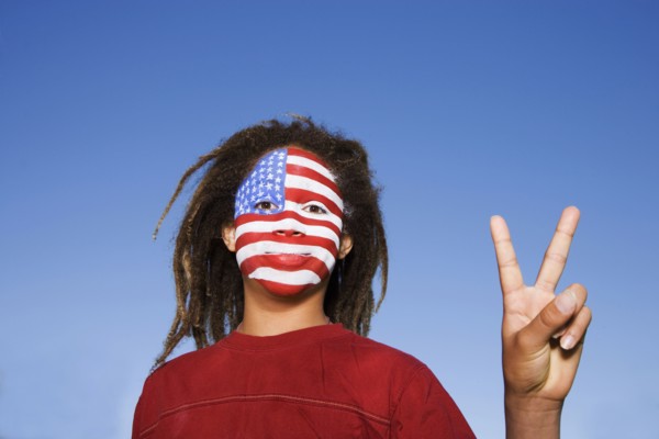 Mixed race boy with American flag painted on face