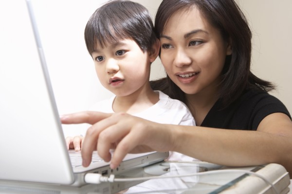 Filipino mother and son using laptop together