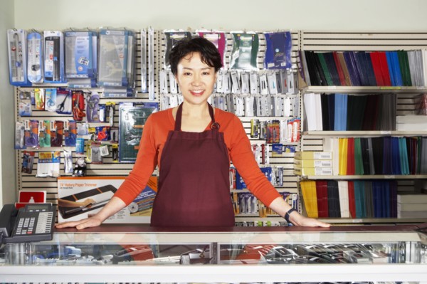 Chinese woman working in office supply store