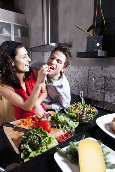 Couple cooking together in kitchen