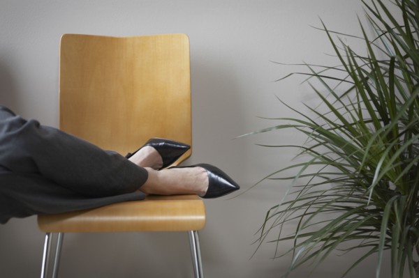 Close up of businesswoman's feet on chair