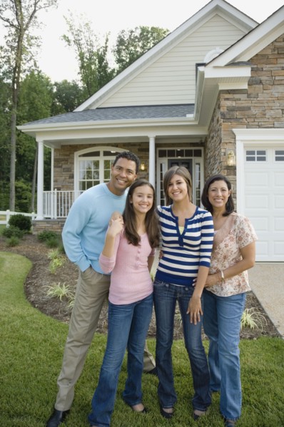 Hispanic family in front of house