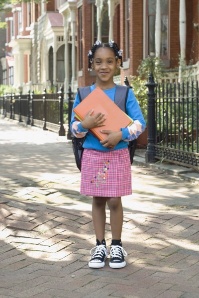 African girl holding school books