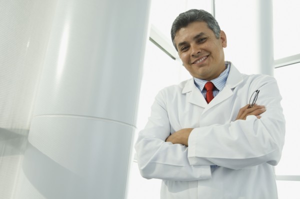 Hispanic male doctor with arms crossed