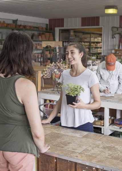 Caucasian mother and daughter talking in store