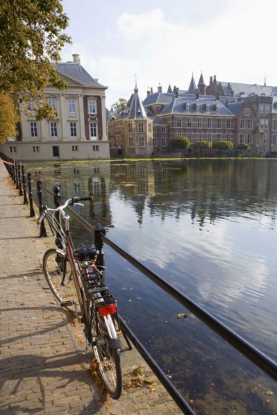 Bicycle and ornate Dutch buildings near pond