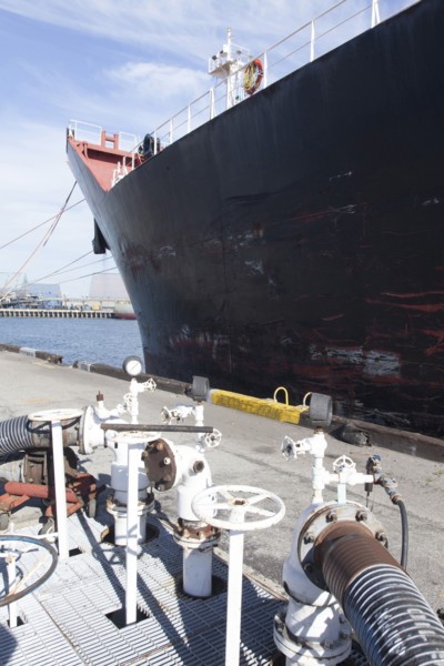 Oil tanker ship docked in industrial harbor