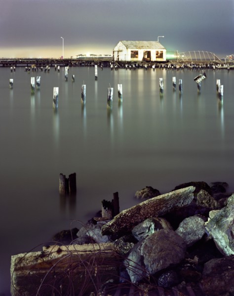 Pillars in still water at night