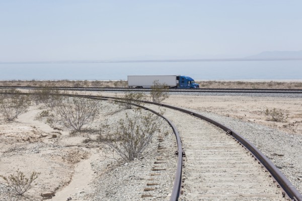 Semi-trick driving near railroad track