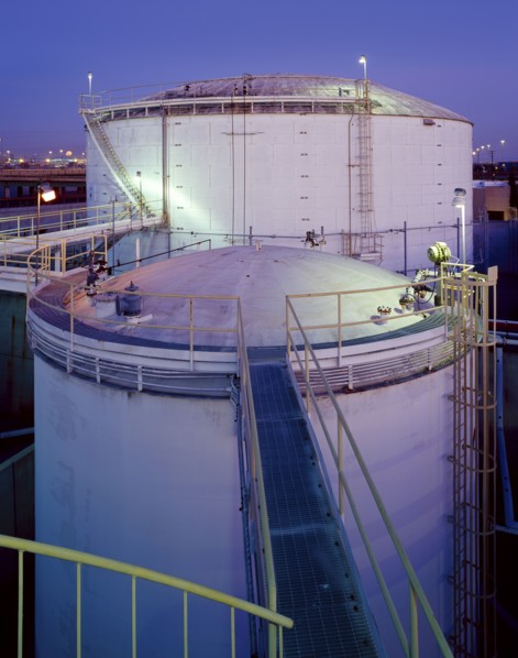 Footbridge on storage tanks at night