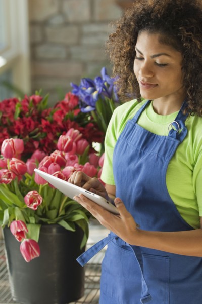 Mixed race florist using digital tablet