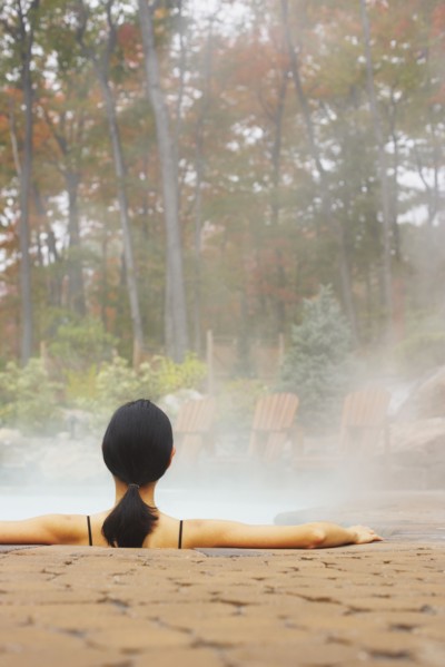 Rear view of woman sitting in hot tub