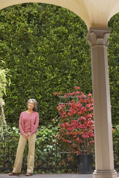 Smiling woman standing in garden