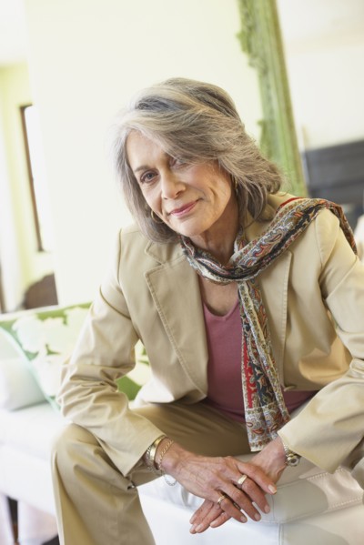 Confident woman sitting in living room