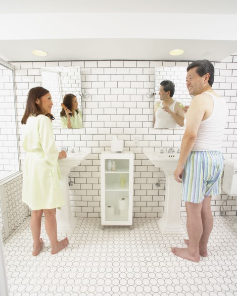 Asian husband and wife in bathroom together