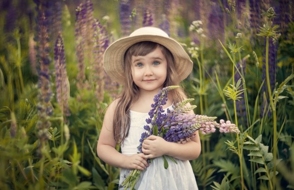 Caucasian girl holding bouquet of wildflowers