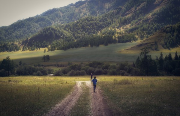 Caucasian boys walking on remote path