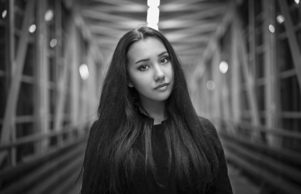 Portrait of serious Mixed Race teenage girl on footbridge