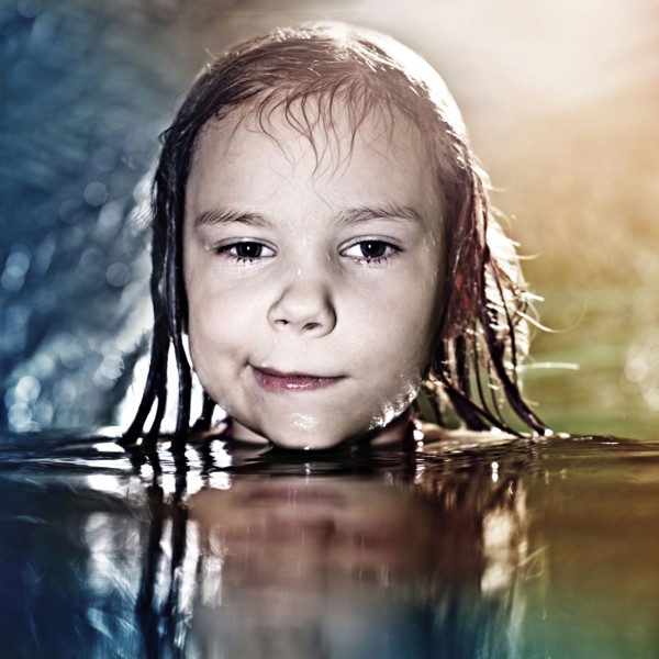 Caucasian girl swimming in water