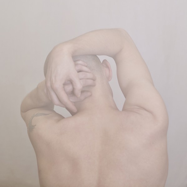 Caucasian man clutching his head