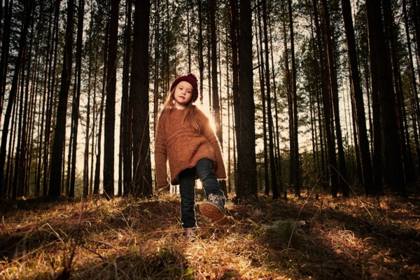 Caucasian girl playing in forest