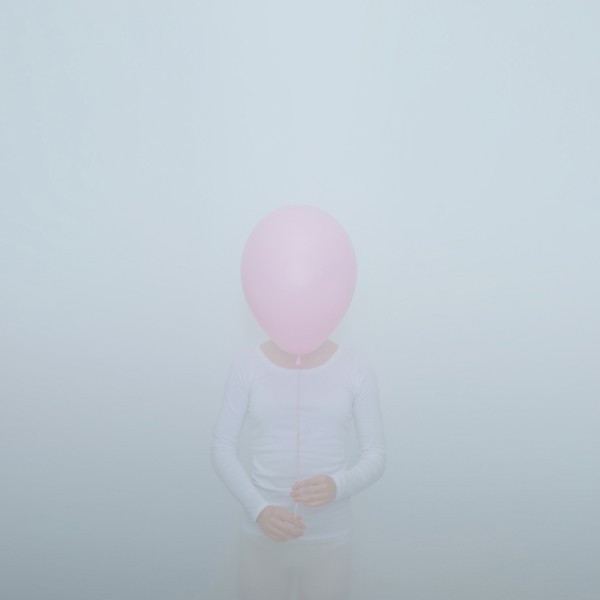 Caucasian teenage girl holding balloon