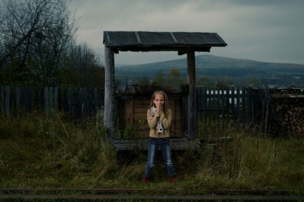 Caucasian girl waiting at rural train stop