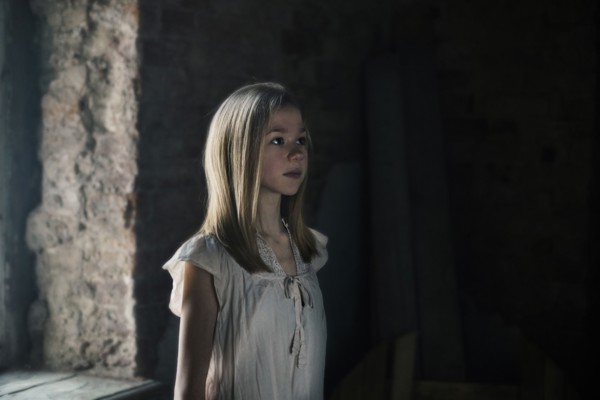 Caucasian girl standing at window