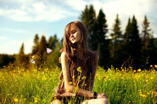 Caucasian woman sitting in field