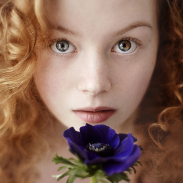 Caucasian teenage girl holding flower