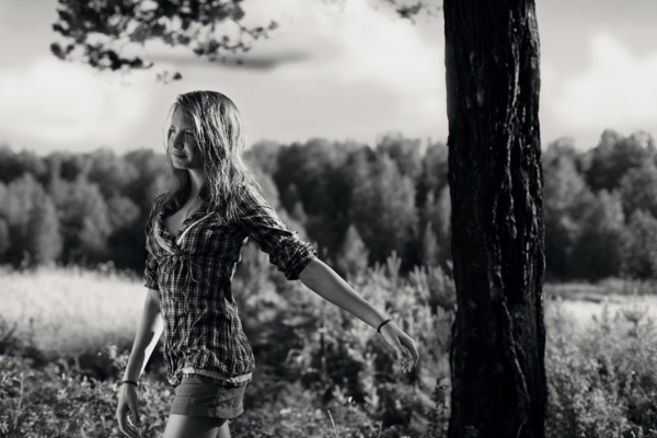 Caucasian girl walking near tree