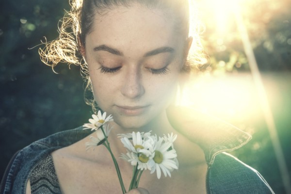 Caucasian woman smelling flowers