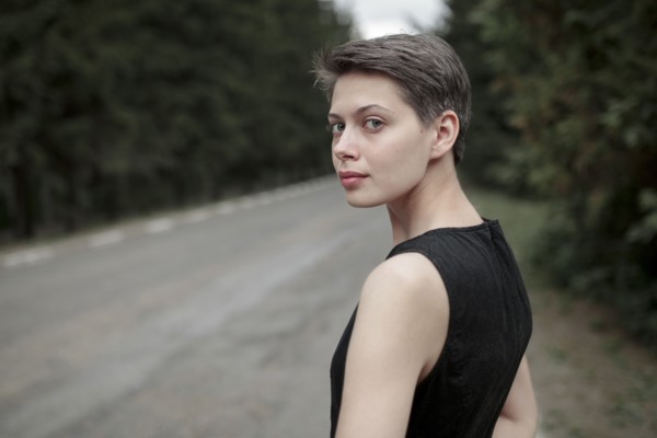 Caucasian woman standing near road