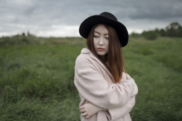 Asian woman standing in field