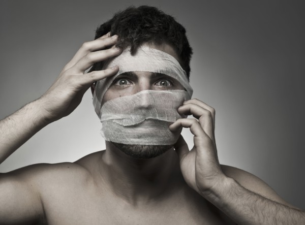 Man with bandages on his face