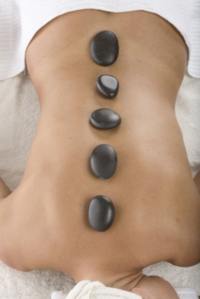 Caucasian woman having hot stone massage