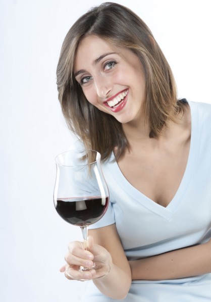 Smiling woman having glass of wine
