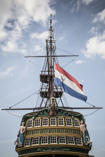 Flag flying from pirate ship against blue sky