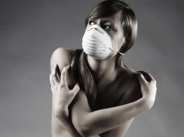 Naked Caucasian woman wearing pollution mask
