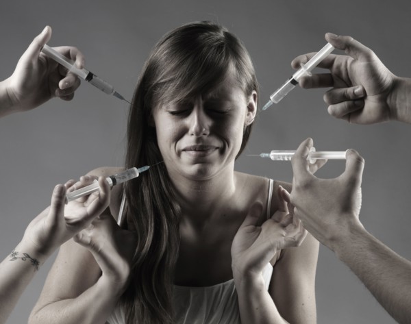 Caucasian woman fearing syringes
