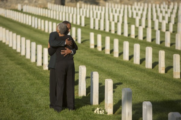 Black couple hugging in military cemetery