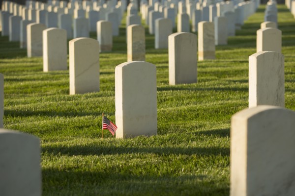 American flag at cemetery gravestone