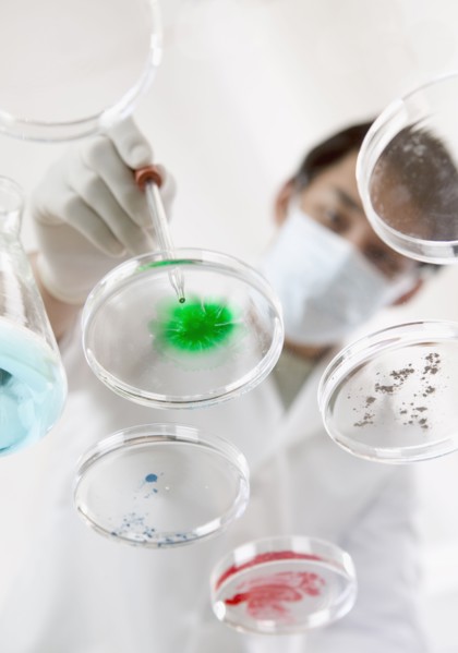 Man in lab with petri dishes