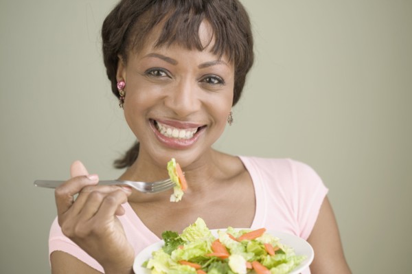 Portrait of woman eating salad