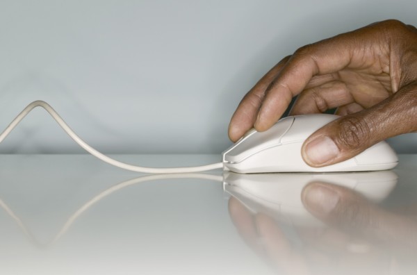 Close up of hands on computer mouse