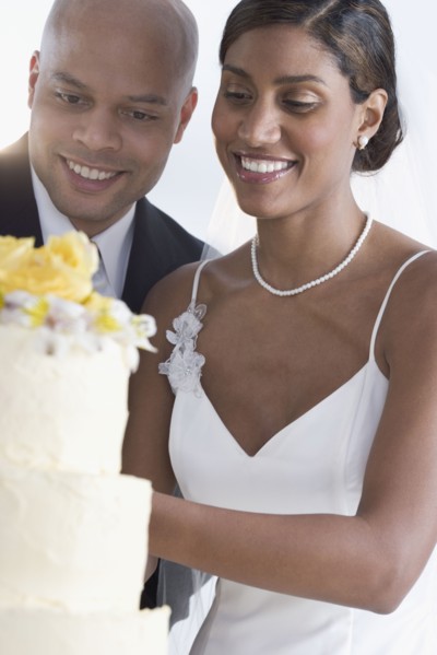 Bride and groom cutting cake