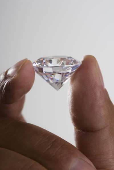 Close up of hand holding diamond