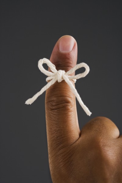 Close up of finger tied in bow