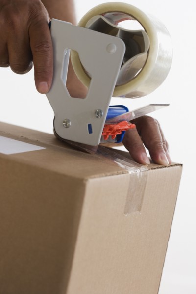 Close up of hands taping up box
